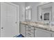 Bathroom featuring double sinks with granite countertop, ample storage, and modern fixtures at 350 Stephens Way, Youngsville, NC 27596