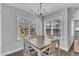 Bright dining room with a view of the backyard and a modern chandelier at 350 Stephens Way, Youngsville, NC 27596