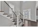 Elegant foyer with hardwood floors, staircase with metal railings, and a glass-paneled front door at 350 Stephens Way, Youngsville, NC 27596