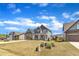 Beautiful home with gray siding and stone accents, complemented by a well-maintained lawn and landscaping at 350 Stephens Way, Youngsville, NC 27596