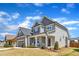 Beautiful two-story home with gray siding, stone accents, manicured lawn, and inviting curb appeal at 350 Stephens Way, Youngsville, NC 27596