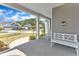 Covered front porch with white bench and rocking chair offering neighborhood views at 350 Stephens Way, Youngsville, NC 27596