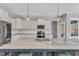 Contemporary kitchen with an island, white cabinets, stainless steel appliances, and open design to dining area at 350 Stephens Way, Youngsville, NC 27596