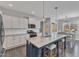 Modern kitchen with a large island, white cabinetry, stainless steel appliances, and stylish pendant lighting at 350 Stephens Way, Youngsville, NC 27596
