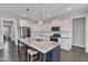 Stylish kitchen featuring a large island, stainless steel appliances, and white cabinets with modern finishes at 350 Stephens Way, Youngsville, NC 27596