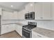 Bright kitchen featuring white cabinets, stainless steel appliances, and plenty of counter space at 350 Stephens Way, Youngsville, NC 27596