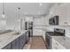 Well-equipped kitchen with stainless steel appliances, white cabinets, and an island with a sink at 350 Stephens Way, Youngsville, NC 27596