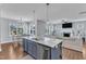 Open-concept kitchen, dining, and living area with hardwood floors and lots of natural light at 350 Stephens Way, Youngsville, NC 27596