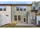 Back of home features a patio area and light green siding and a white fence at 3735 Landshire View Ln, Raleigh, NC 27616
