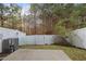 View of a private backyard with white vinyl fencing, HVAC unit, and a small concrete patio at 3735 Landshire View Ln, Raleigh, NC 27616