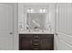 Bathroom with double vanity, white countertops, and white cabinets at 3735 Landshire View Ln, Raleigh, NC 27616