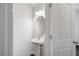 Bathroom featuring a modern pedestal sink, framed mirror, and a tiled floor at 3735 Landshire View Ln, Raleigh, NC 27616