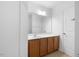 Bathroom featuring wood cabinets, a large mirror, and ample counter space at 3735 Landshire View Ln, Raleigh, NC 27616