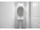 Bathroom featuring a modern pedestal sink, framed mirror, and a tiled floor at 3735 Landshire View Ln, Raleigh, NC 27616