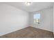 Well-lit bedroom with neutral carpet, clean walls, and a bright window at 3735 Landshire View Ln, Raleigh, NC 27616