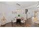 Dining area features wood floors, modern lighting, and a view into the stairwell and kitchen at 3735 Landshire View Ln, Raleigh, NC 27616