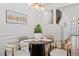 Dining area features wood floors, modern lighting, and four decorated table settings at 3735 Landshire View Ln, Raleigh, NC 27616