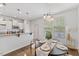 Dining area features wood floors, modern lighting, and an adjacent kitchen area at 3735 Landshire View Ln, Raleigh, NC 27616