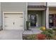 Close up of the front entrance and garage highlighting landscaping and Vivint security system sign at 3735 Landshire View Ln, Raleigh, NC 27616