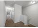 Hallway with carpet, a linen closet, and stairway access to the upper level at 3735 Landshire View Ln, Raleigh, NC 27616