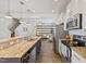 Bright kitchen featuring stainless steel appliances, granite countertops, and an open floor plan to living area at 3735 Landshire View Ln, Raleigh, NC 27616