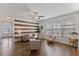 Bright living room featuring a modern design with neutral paint, wood accent wall, and many windows at 3735 Landshire View Ln, Raleigh, NC 27616