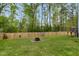 Fenced backyard with an outdoor fire pit area at 375 Alcock Ln, Youngsville, NC 27596