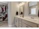 Bright bathroom with double sink vanity, decorative mirrors, and tiled floors at 375 Alcock Ln, Youngsville, NC 27596
