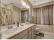 Bathroom featuring a double sink vanity, neutral tones, and a shower with decorative curtain at 375 Alcock Ln, Youngsville, NC 27596