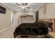 Bedroom with wood bed frame, ceiling fan, neutral walls, and an adjacent doorway at 375 Alcock Ln, Youngsville, NC 27596