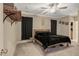 Cozy bedroom featuring a wooden bed frame, ceiling fan, and unique wall decor at 375 Alcock Ln, Youngsville, NC 27596