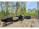 Wooden deck overlooking the backyard featuring a grill and outdoor furniture at 375 Alcock Ln, Youngsville, NC 27596