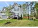 Well-maintained two-story home with a spacious, lush green lawn and mature landscaping at 375 Alcock Ln, Youngsville, NC 27596