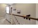 Upstairs hallway showcasing a railing and artwork on the wall at 375 Alcock Ln, Youngsville, NC 27596