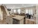 Open concept kitchen with island and stainless dishwasher flowing into the dining room at 375 Alcock Ln, Youngsville, NC 27596