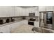 Well-lit kitchen featuring white cabinets, granite countertops, and stainless steel appliances at 375 Alcock Ln, Youngsville, NC 27596