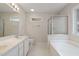 Bright, all-white bathroom with double vanity, garden tub, separate shower, and natural light at 378 E Raleigh Ave, Liberty, NC 27298