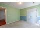 Two-toned bedroom with large closet, neutral carpet, and view to hallway at 378 E Raleigh Ave, Liberty, NC 27298