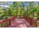 Beautiful wood deck overlooking a serene backyard with mature trees at 378 E Raleigh Ave, Liberty, NC 27298