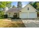 Charming home with a two-car garage, meticulously landscaped front yard, and well-maintained lawn at 378 E Raleigh Ave, Liberty, NC 27298