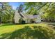 Home featuring a well-manicured lawn, mature trees, an attached two-car garage, and a front entrance at 378 E Raleigh Ave, Liberty, NC 27298