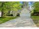 Charming home with a two-car garage, a well-maintained lawn, and mature trees at 378 E Raleigh Ave, Liberty, NC 27298