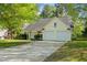 Inviting home showcasing a well-manicured lawn, a two-car garage, and classic exterior finishes at 378 E Raleigh Ave, Liberty, NC 27298