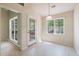Kitchen and dining area with ample natural light, featuring access to the living room and outdoors at 378 E Raleigh Ave, Liberty, NC 27298