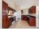 Well-equipped kitchen with ample storage, essential appliances, and functional layout, tiled flooring at 378 E Raleigh Ave, Liberty, NC 27298
