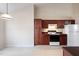 Functional kitchen featuring dark cabinetry, essential appliances, and ample counter space, with tile flooring at 378 E Raleigh Ave, Liberty, NC 27298