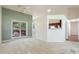 Living room features an outdoor deck visible through a large window, with a kitchen view at 378 E Raleigh Ave, Liberty, NC 27298