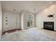 Bright living room featuring large windows, a fireplace, and neutral carpeting at 378 E Raleigh Ave, Liberty, NC 27298
