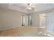 The carpeted main bedroom includes a ceiling fan, multiple closets, and an en-suite bathroom at 378 E Raleigh Ave, Liberty, NC 27298