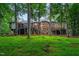 Sprawling backyard featuring a stately home with expansive windows and multiple decks for outdoor living at 417 Swans Mill Xing, Raleigh, NC 27614